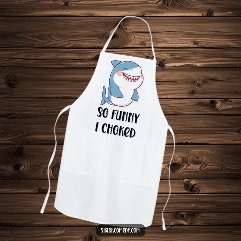 Funny giggling shark apron showing a shark laughing uncontrollably while holding its belly, designed for cooks who love humor.