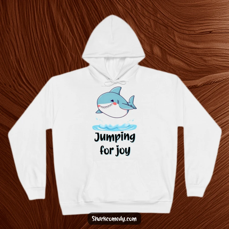 Funny Small Shark Hoodie featuring a small shark with a silly grin, captured mid-jump out of the water, offering warmth and humor.