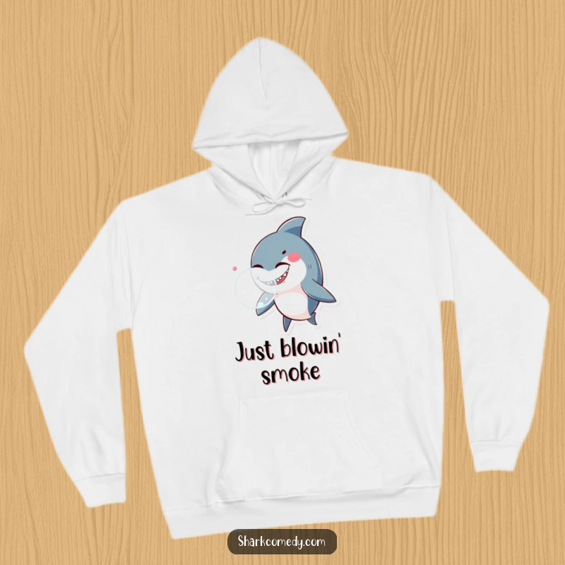 Funny shark winking playfully while blowing a big bubble, depicted on a soft hoodie, ideal for cozy, humorous wear.