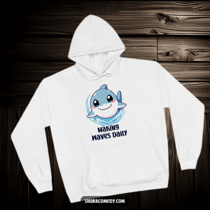 Funny shark hoodie depicting a cute character with wide eyes, swimming at high speed and splashing water, combining warmth with playful ocean vibes.