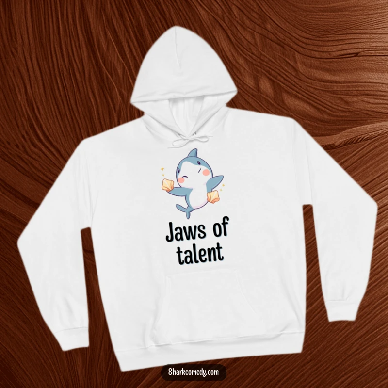 Funny shark hoodie, a comfortable garment featuring a shark winking and juggling three shiny seashells, embodying cool underwater performance.