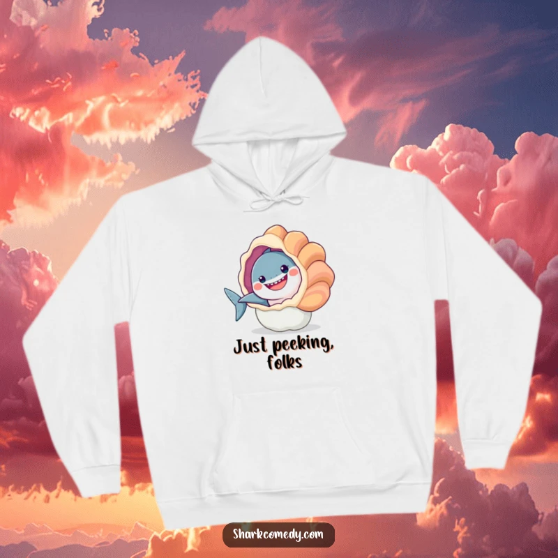 Funny hoodie design: a cheerful shark peeking from behind a large, colorful seashell. Comfortable and amusing.