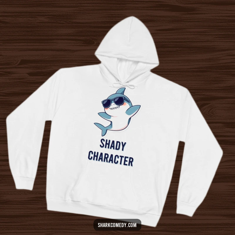 Funny hoodie featuring a kawaii shark wearing sunglasses, doing a playful flip, perfect for cozy, cool moments.