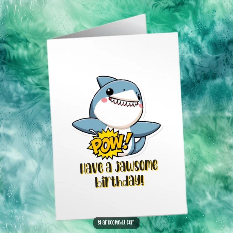 Funny Free Printable Birthday Card featuring an excited shark character holding a speech bubble with a comic book POW! graphic. Energetic and fun.