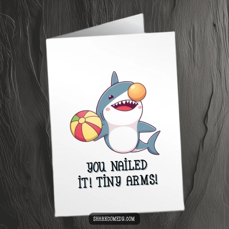 Funny Free Printable congratulations card: a shark with very small arms attempts to balance a beach ball on its nose.
