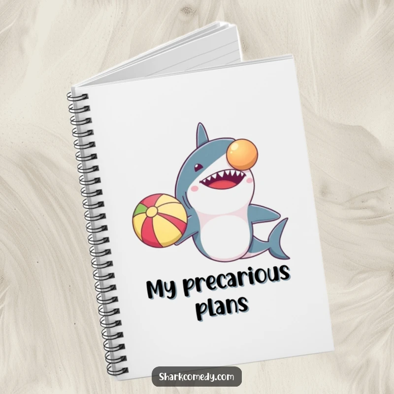 Funny notebook cover: a shark with comically small arms trying to balance a beach ball on its nose. Ideal for note-taking.