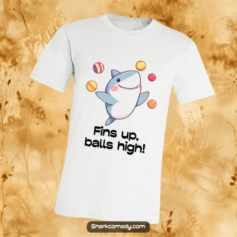 Funny t-shirt graphic of a shark enthusiastically juggling colorful balls with its fins, looking utterly delighted.